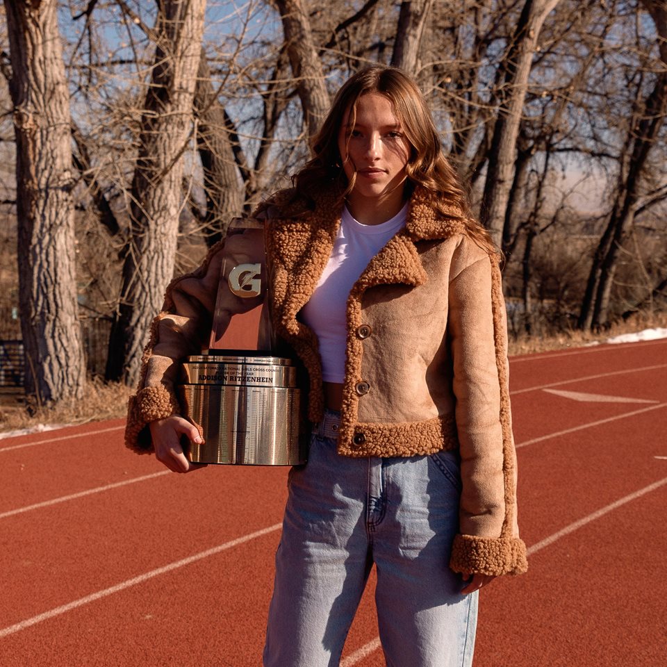 A POY winner posing with their trophy